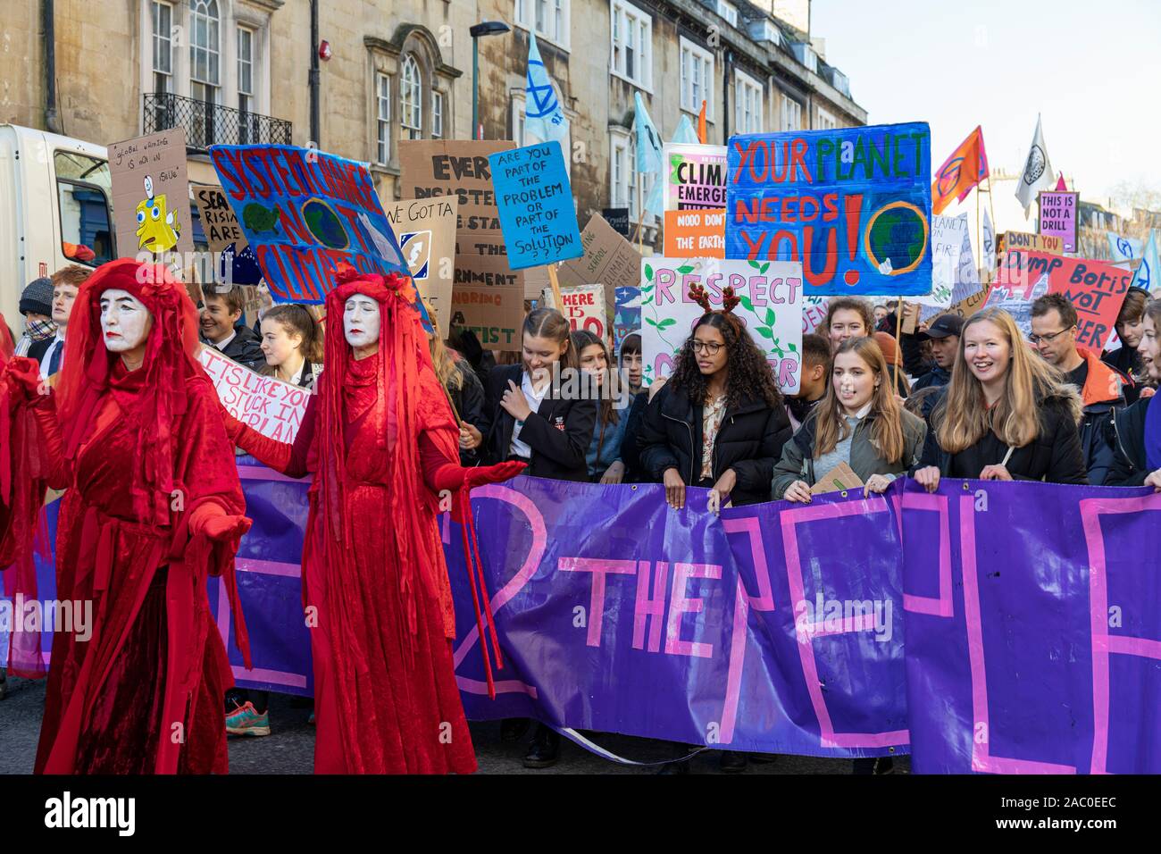 Extinction Rebellion Red Brigade climate change protesters march through Bath City centre with Bath Youth Climate Alliance campaigning for action of Climate Change. Bath UK. 29th November, 2019, England, UK Stock Photo