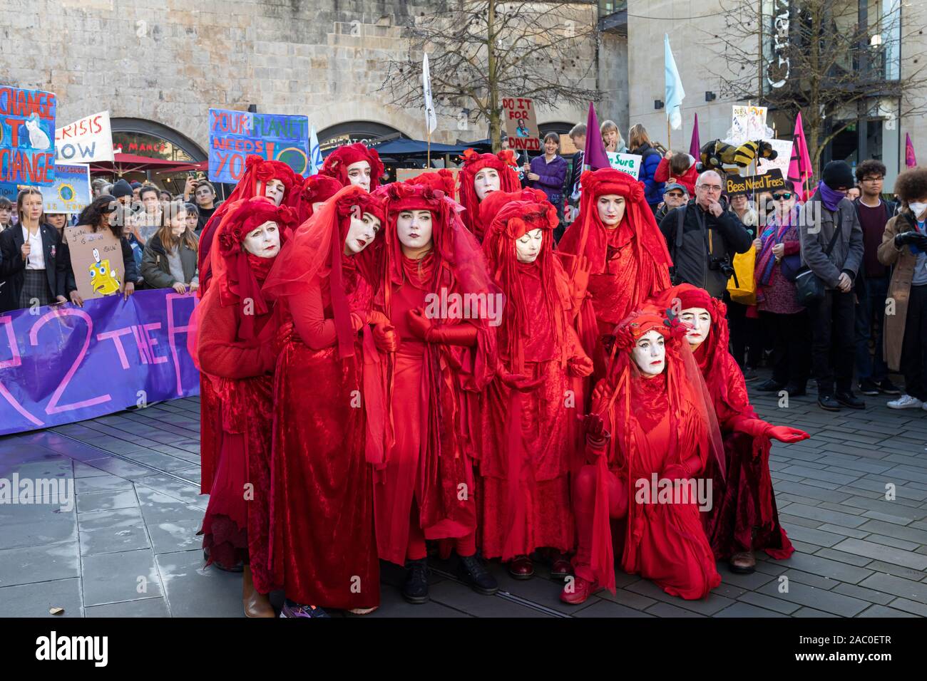 Extinction Rebellion Red Brigade climate change protesters march through Bath City centre with Bath Youth Climate Alliance campaigning for action of Climate Change. Bath. 29th November, 2019, England, UK Stock Photo