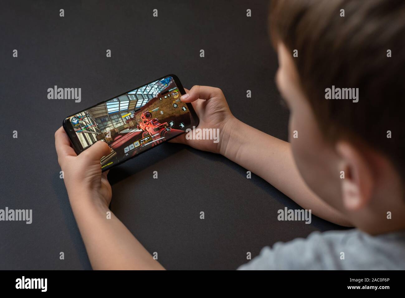 Sarajevo, Bosnia and Herzegovina - November 29, 2019: Call of Duty: Mobile first-person shooter game on modern smart hone in kid hands Stock Photo