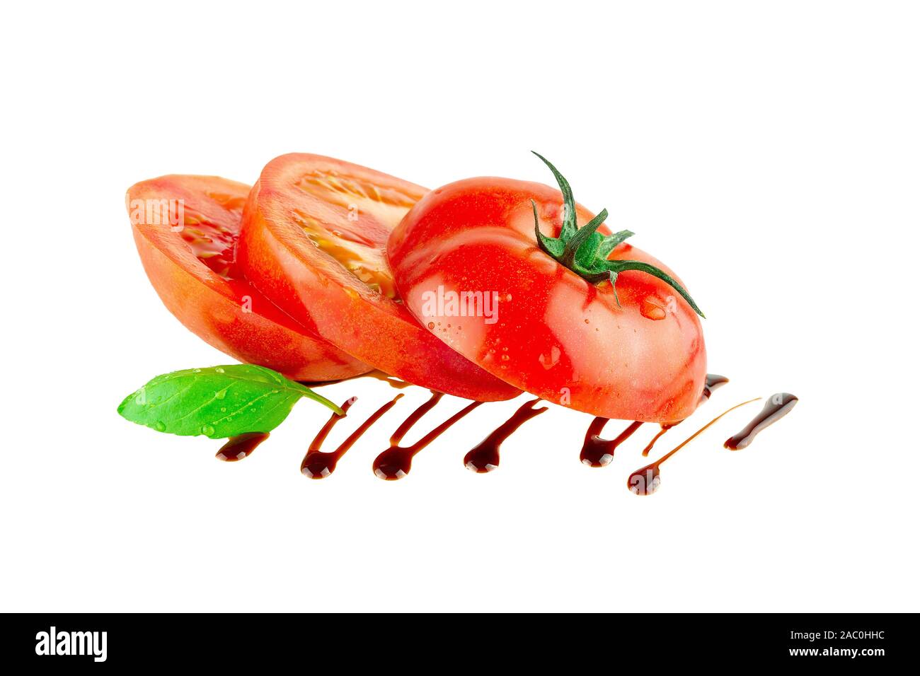 Tomato slices with balsamic vinegar basil leaf  isolated Stock Photo