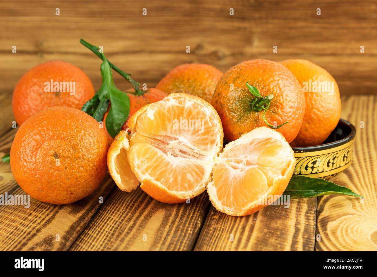 tangerine or mandarin fruits in close up on old wooden background Stock Photo
