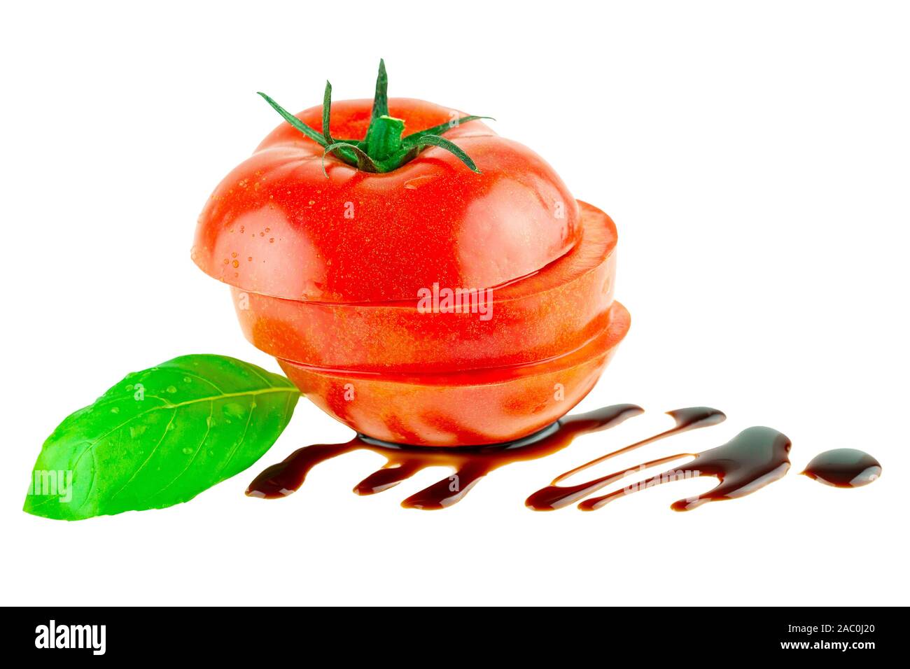 Tomato slisec with green basil leaf and balsamic vinegar isolated Stock Photo