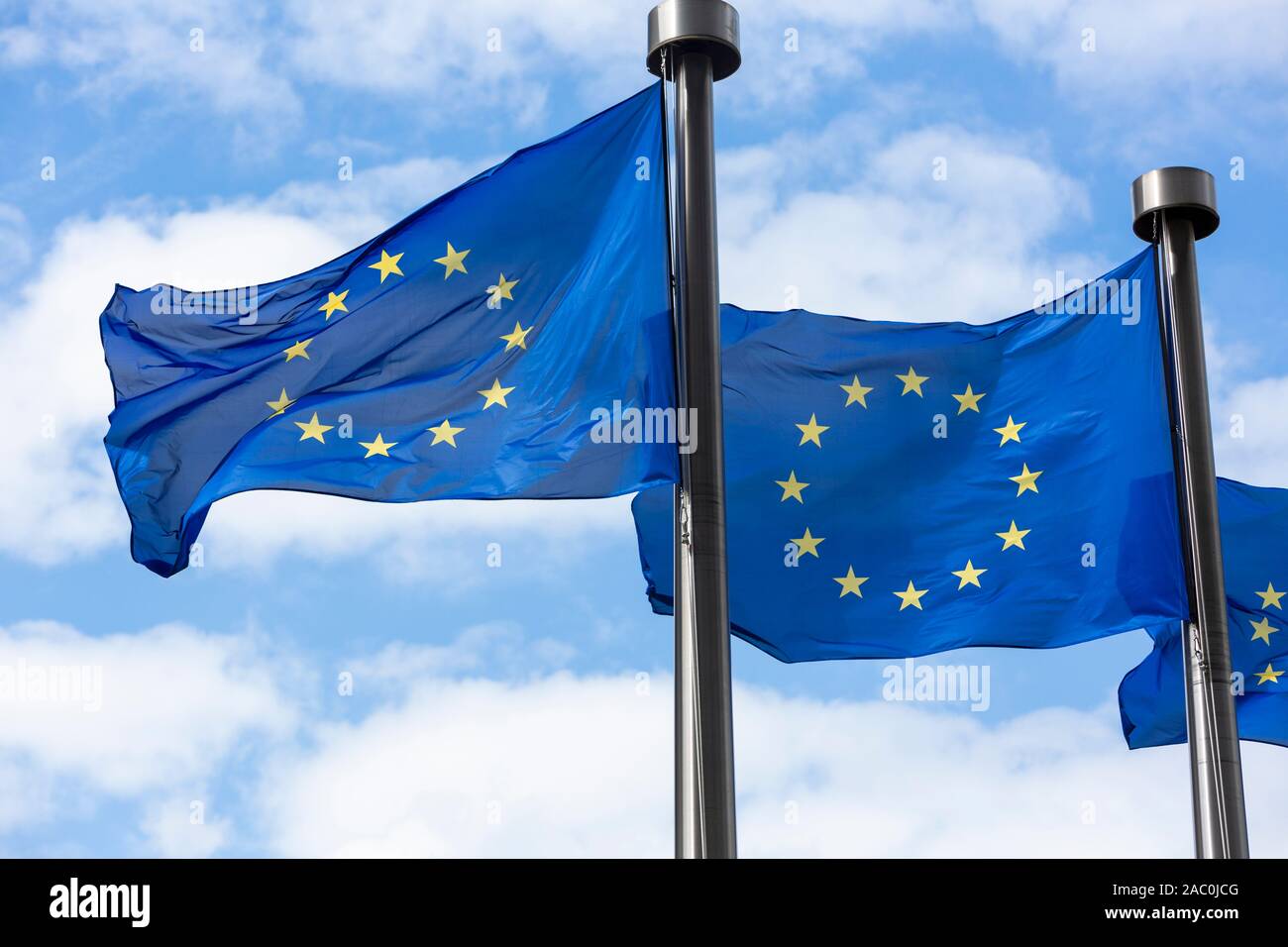 Close up of two European Union Flags flying outside the Berlaymont Building in Brussels, Belgium. Stock Photo