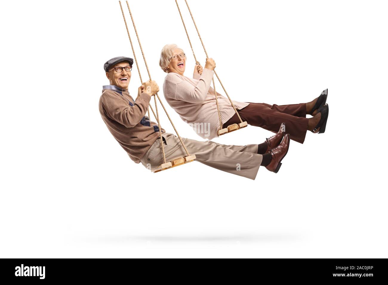 Elderly man and woman swinging and laughing isolated on white background Stock Photo