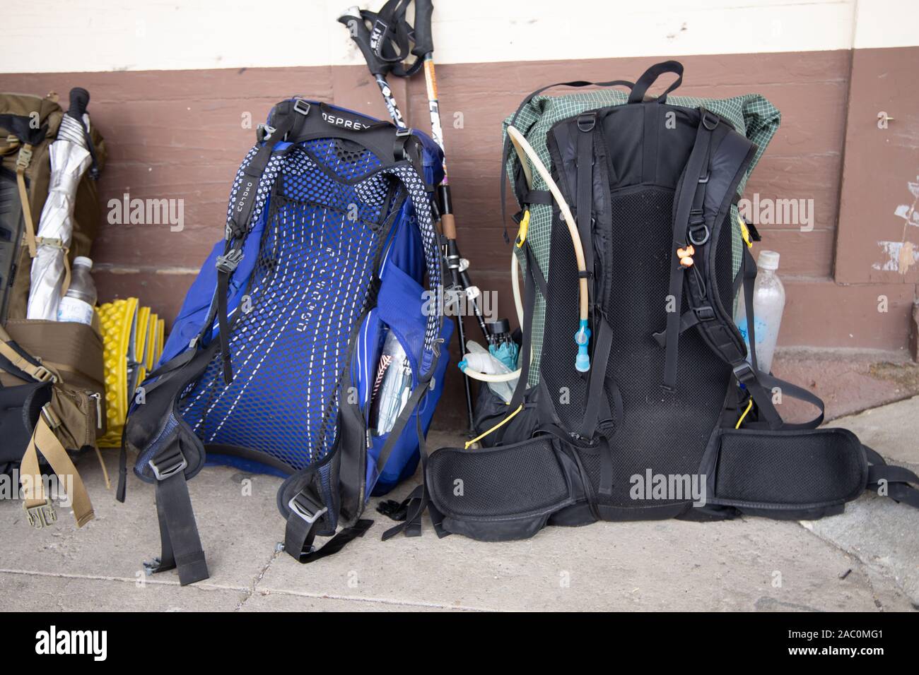 Rucksacks with hikers gear leaning against wall Stock Photo