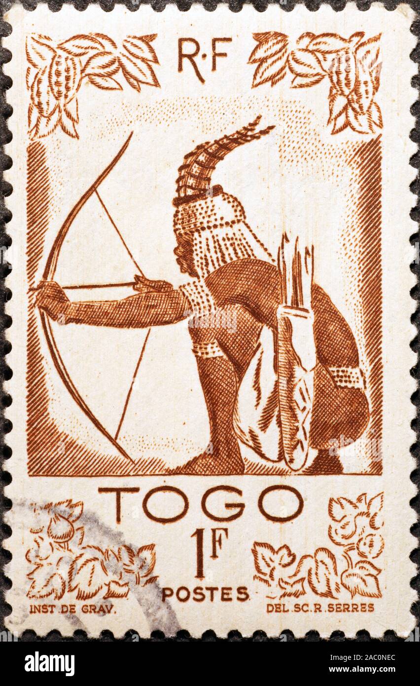 Beautiful postage stamp of Togo with an archer Stock Photo