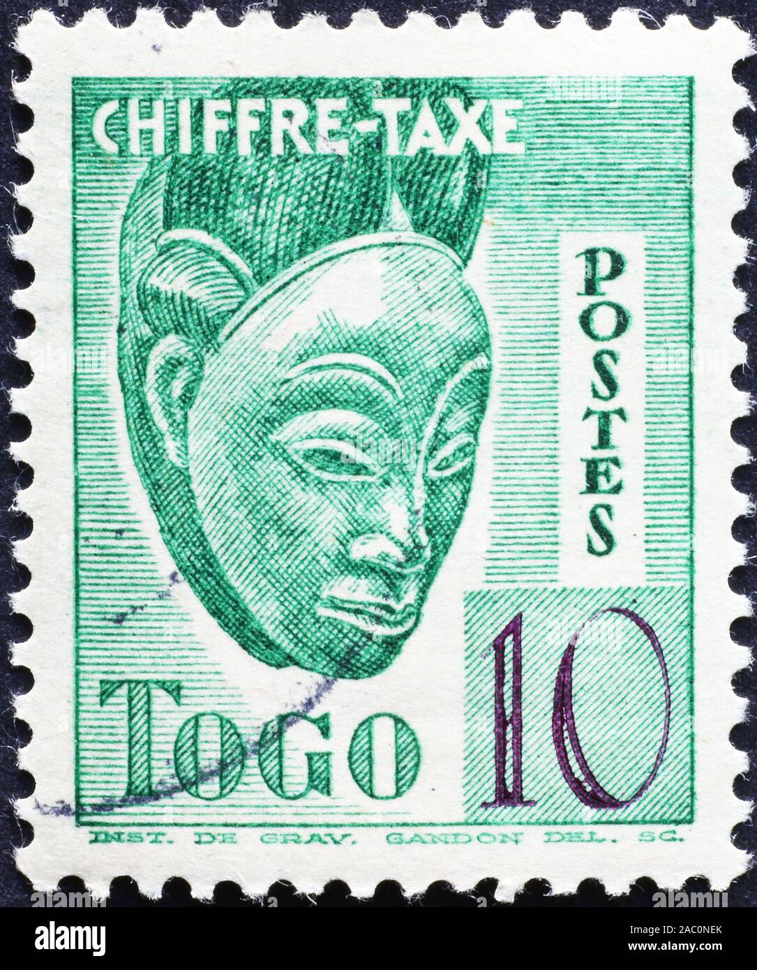 Wooden mask on postage stamp of Togo Stock Photo
