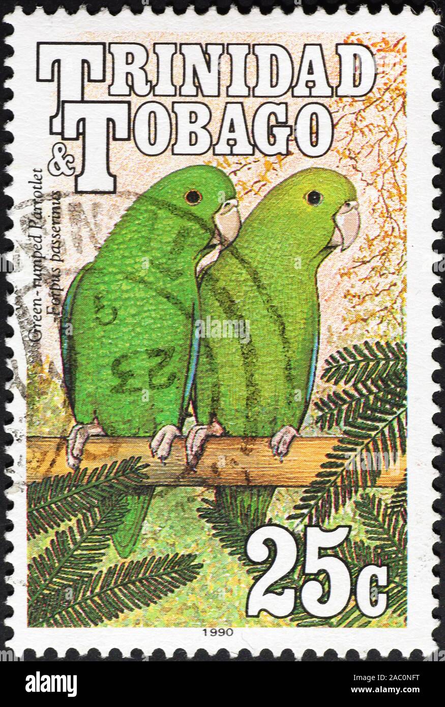 Two green parrotlets on postage stamp of Trinidad Stock Photo