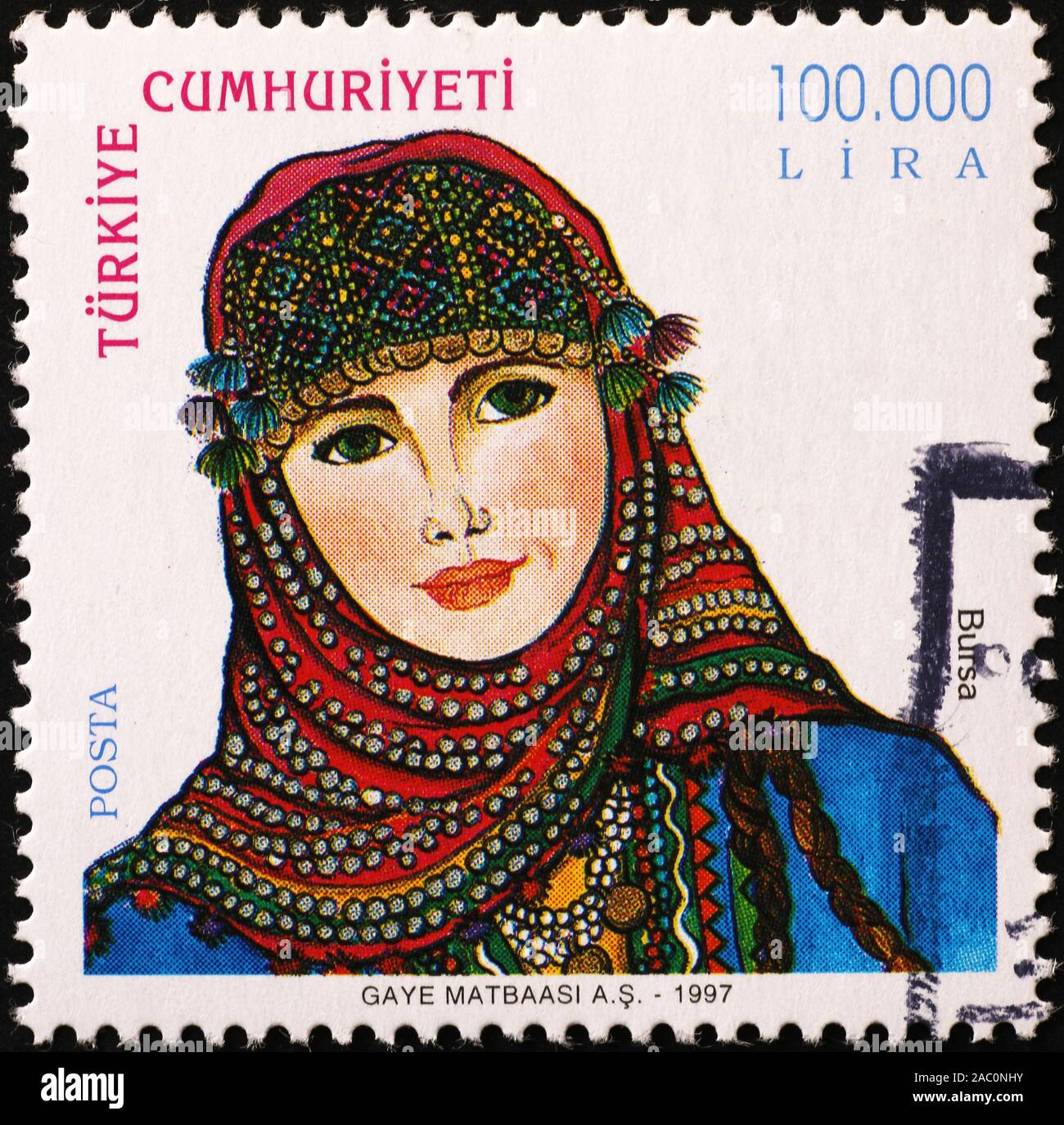 Turkish woman traditionally dressed on postage stamp Stock Photo