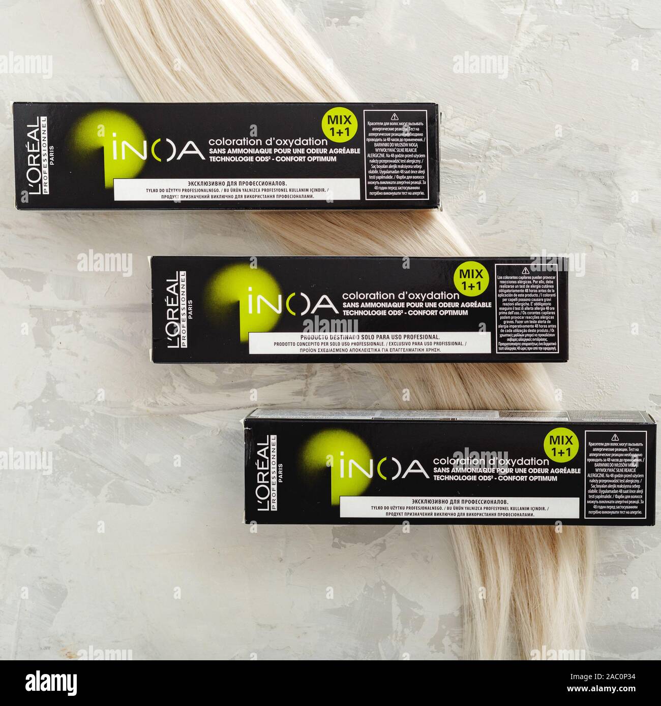 L'oreal professionnel Paris Inoa coloration. Set of professional hair dye  in boxes for hairdressers with strand of blonde hair on gray background  Stock Photo - Alamy