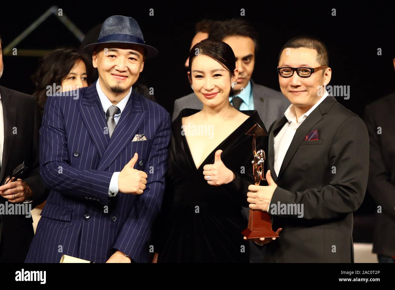 Cairo, Egypt. 29th Nov, 2019. Director Zhang Chong (L) and Zhang Bo (R) of Chinese movie 'The Fourth Wall' and Chinese actress Qin Hailu, who is a member of the international jury, pose for a photo during the awarding ceremony of Cairo International Film Festival in Cairo, Egypt, on Nov. 29, 2019. The 41st edition of Egypt's Cairo International Film Festival (CIFF) concluded Friday night at Cairo Opera House with China's movie 'The Fourth Wall' winning an award at the official film section competition. Credit: Ahmed Gomaa/Xinhua/Alamy Live News Stock Photo