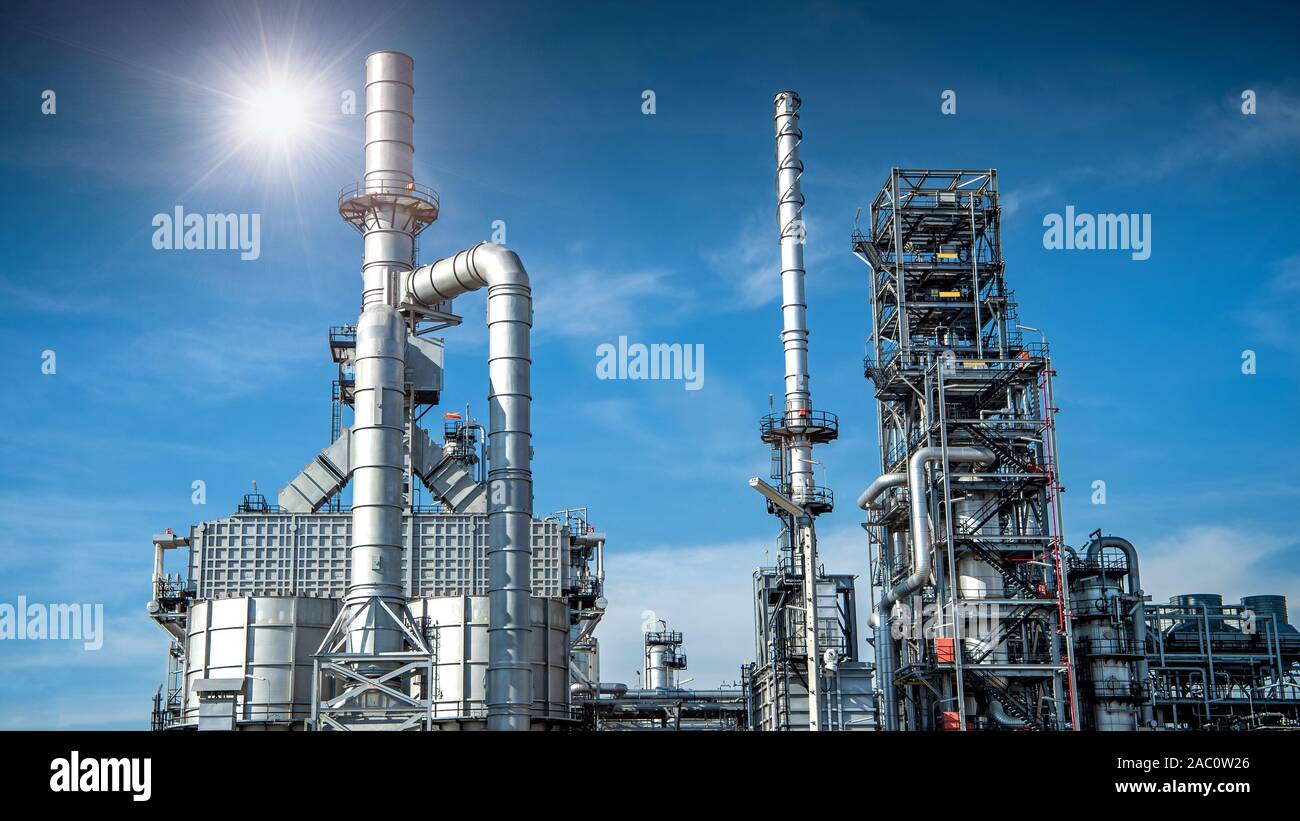 Close-up view Oil and gas industrial refinery zone,Detail of equipment oil pipeline steel with valve from large oil storage tank at cloudy sky. -image Stock Photo