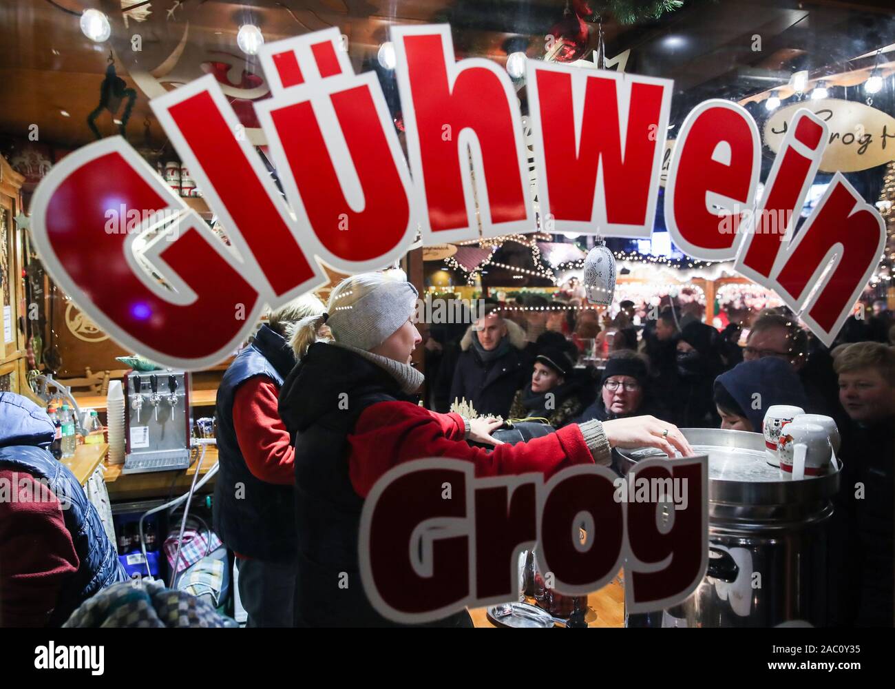 Berlin, Germany. 29th Nov, 2019. Staff members of a shop sell mulled wine at the Christmas market on Breitscheidplatz in Berlin, Germany, on Nov. 29, 2019. Credit: Shan Yuqi/Xinhua/Alamy Live News Stock Photo