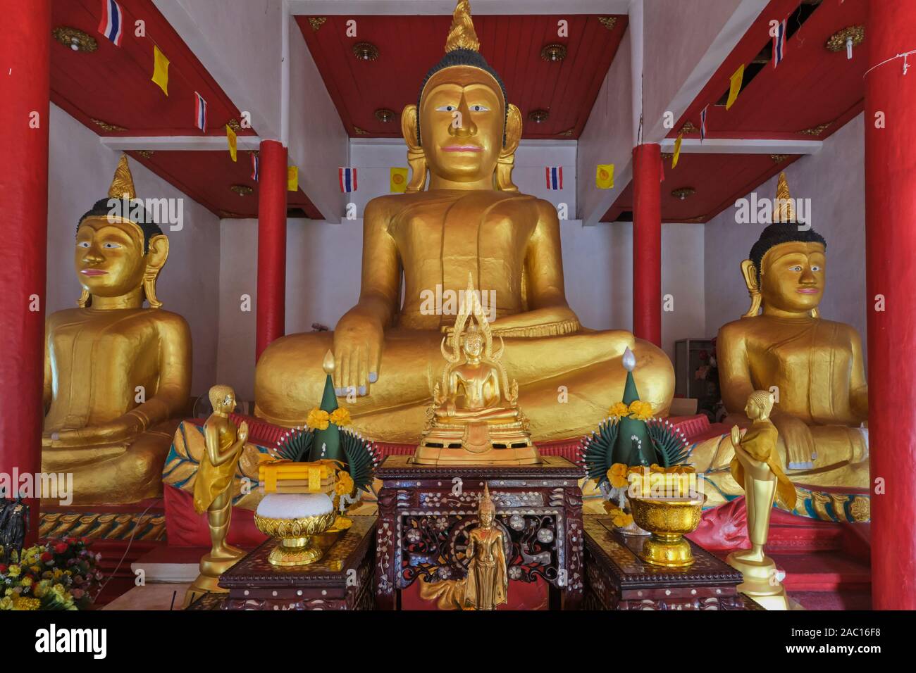 The ancient three tin Buddha statues in the old Bot or Ubosot (ordination hall) of  Wat Phra Nang Sang, Thalang, Phuket, Thailand Stock Photo