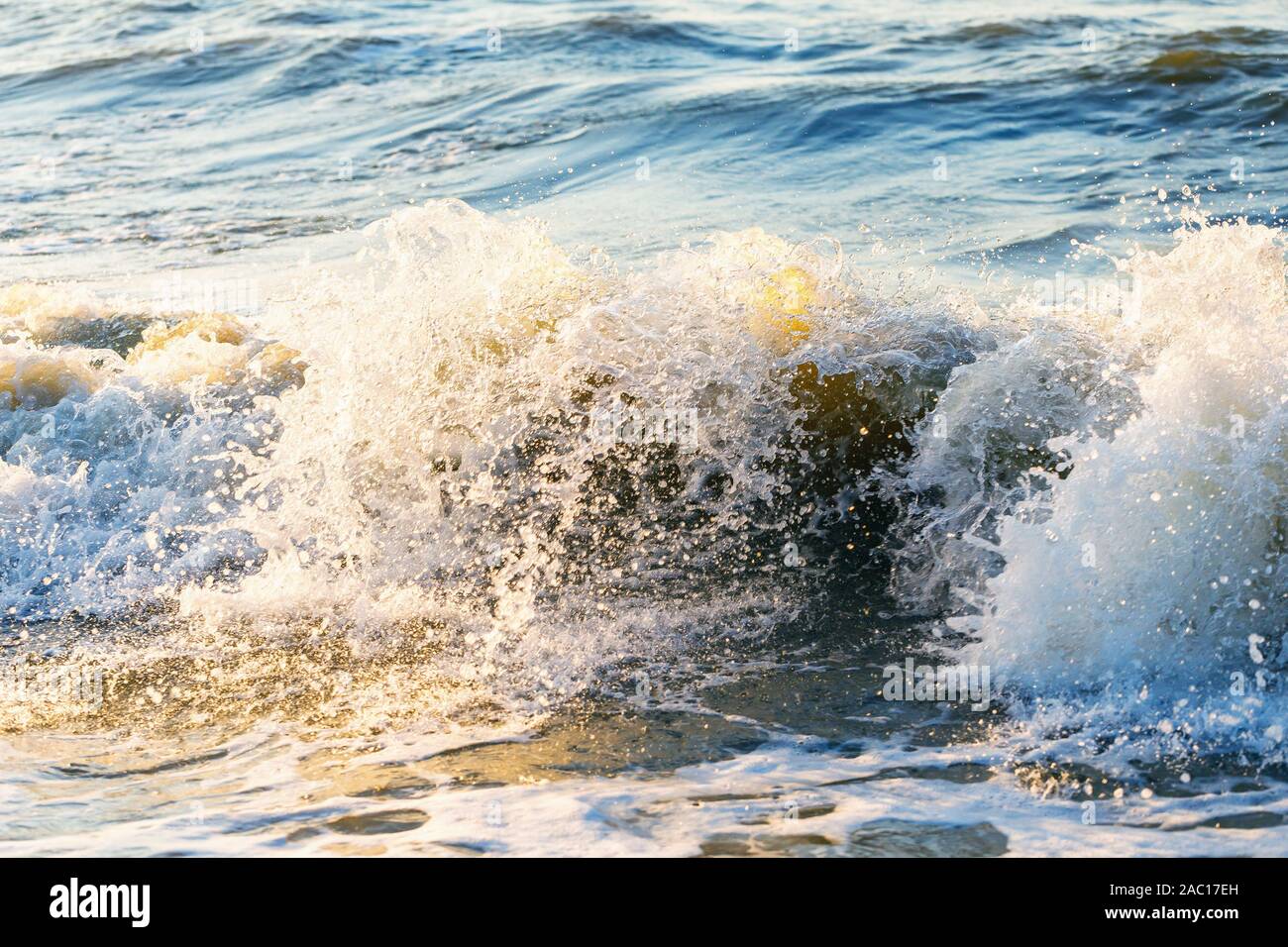 Splashing crashing waves on a sunny evening Stock Photo - Alamy