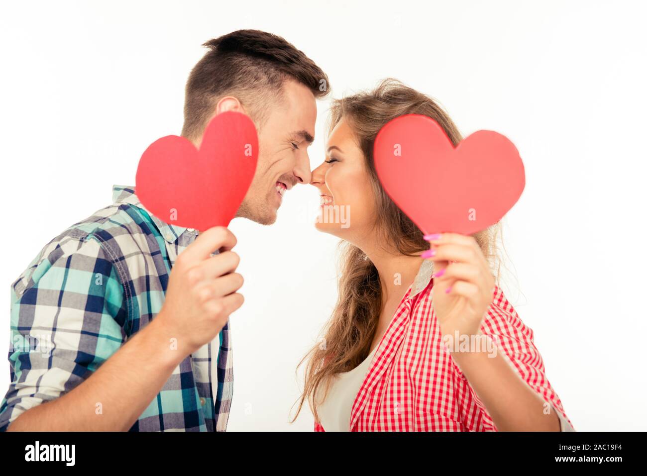 Happy couple in love holding two paper hearts kissing each other Stock ...