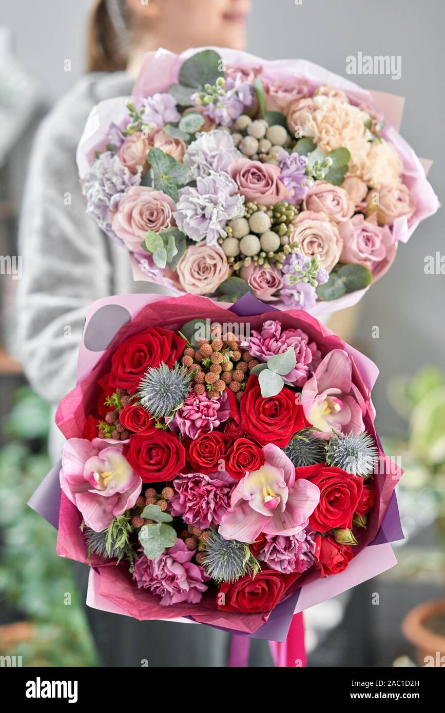 European floral shop. Two Beautiful bouquets of mixed flowers in womans