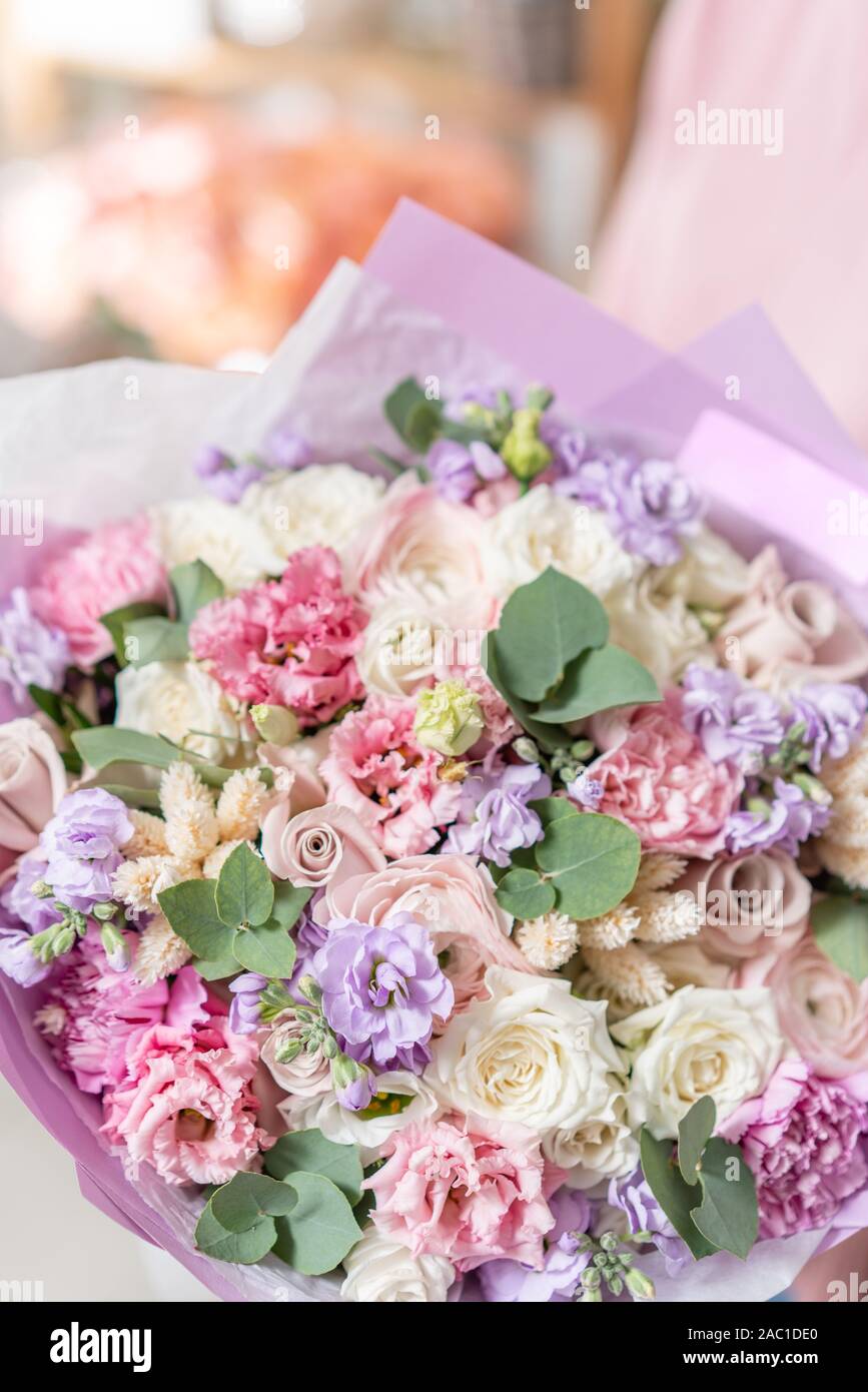 European floral shop. Beautiful bouquet of mixed flowers in womans
