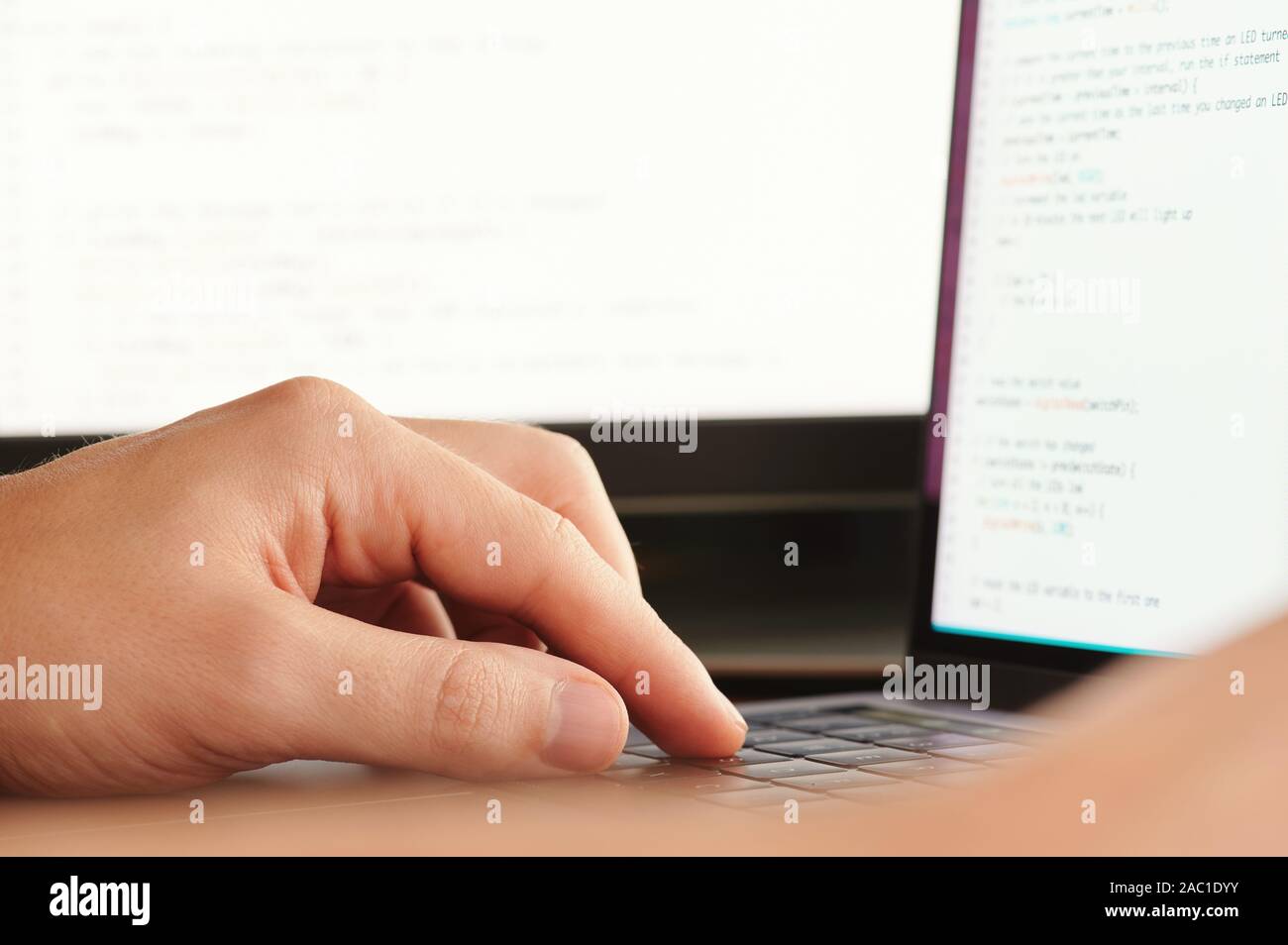 Application programming theme. Man working on computer code Stock Photo ...