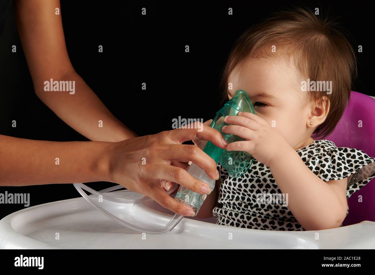 Little baby girl with breathing mask healing after cough sick Stock