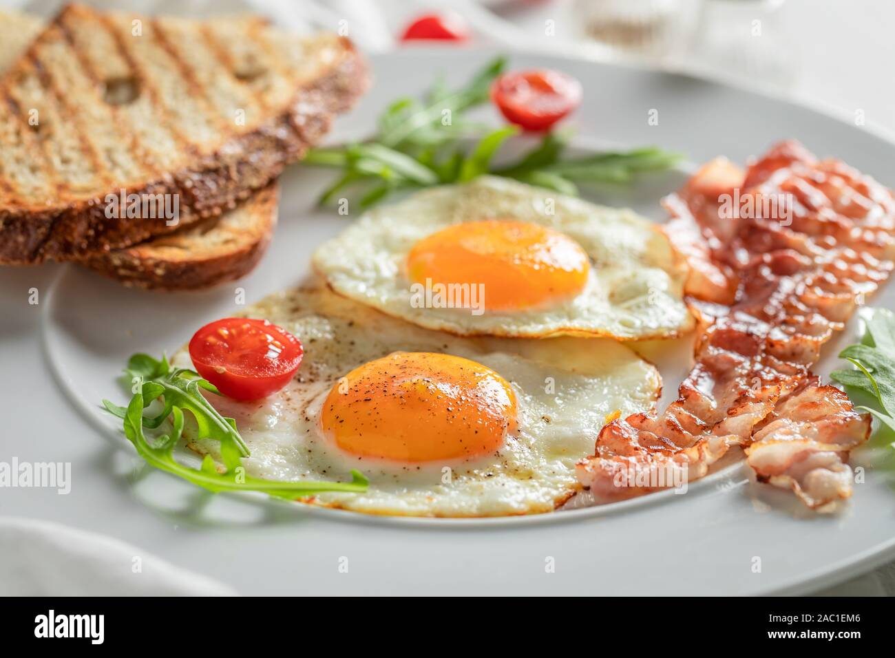 Delicious breakfast with toast, eggs and bacon Stock Photo - Alamy