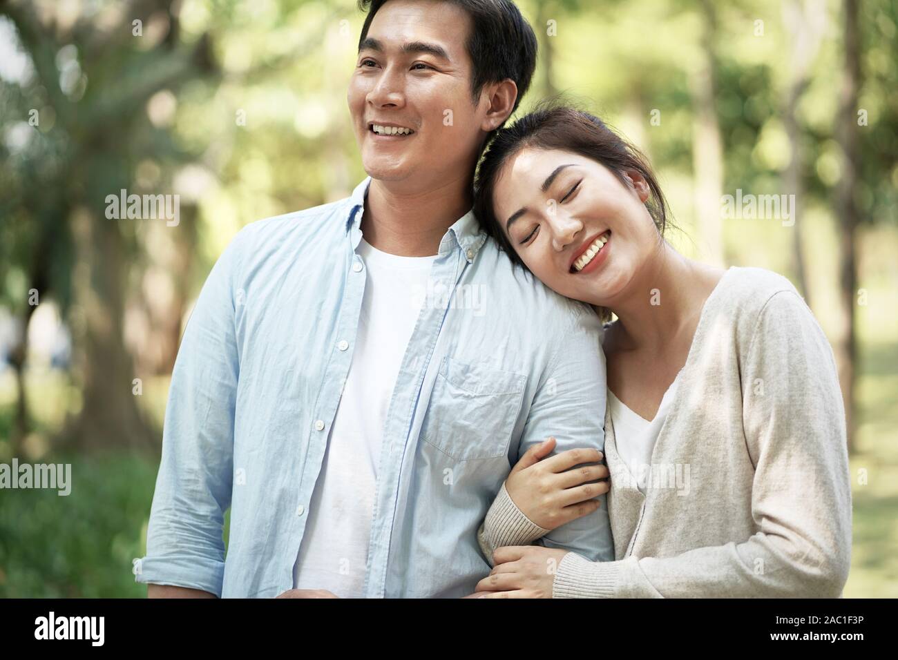 happy loving young asian couple relaxing in park Stock Photo - Alamy