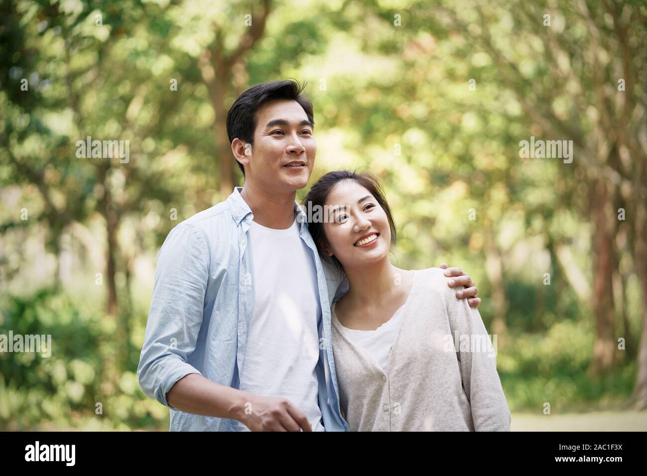happy loving young asian couple relaxing in park Stock Photo