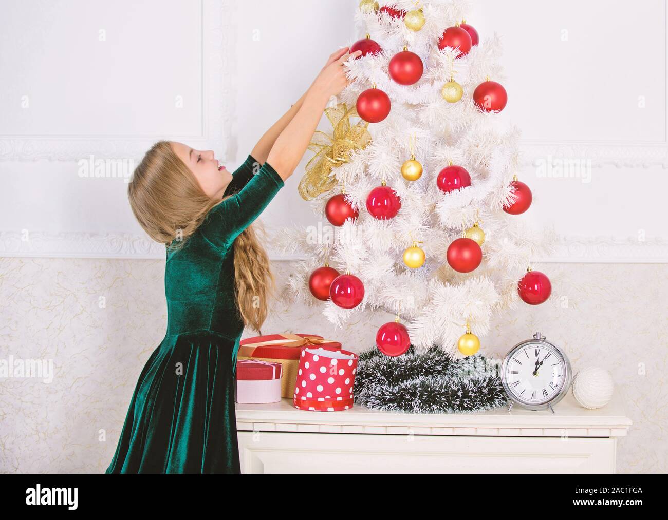 Child Hang Christmas Ornament Ball On Artificial Tree Kids