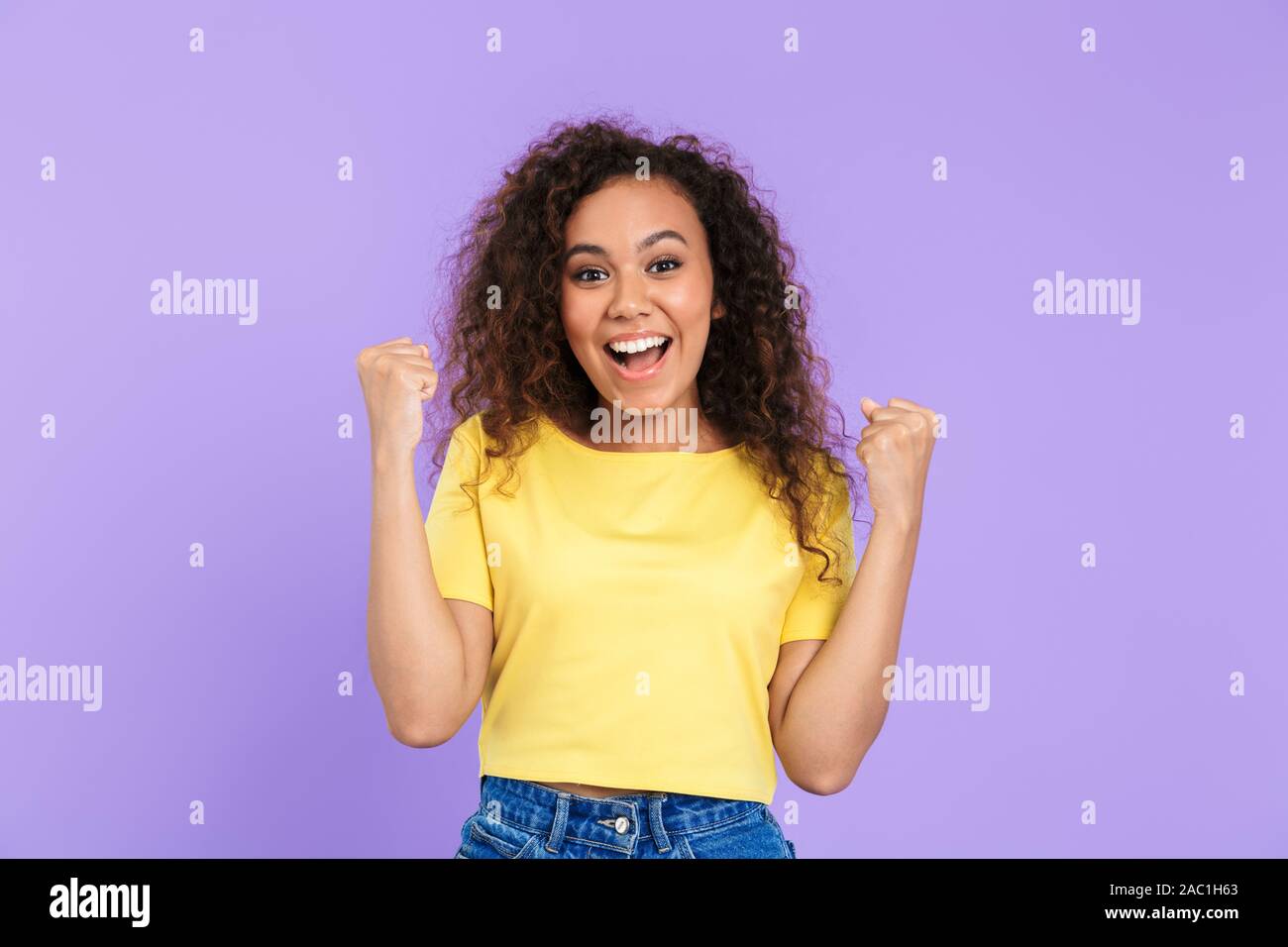 Image of young african american woman with curly hair smiling and ...