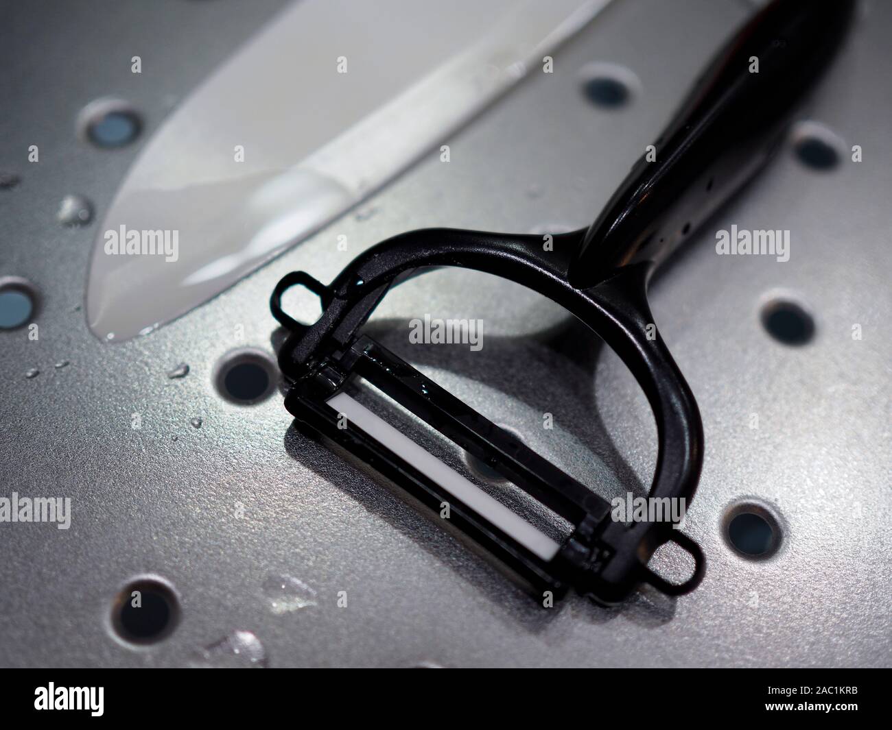 A ceramic potato peeler and knife Stock Photo