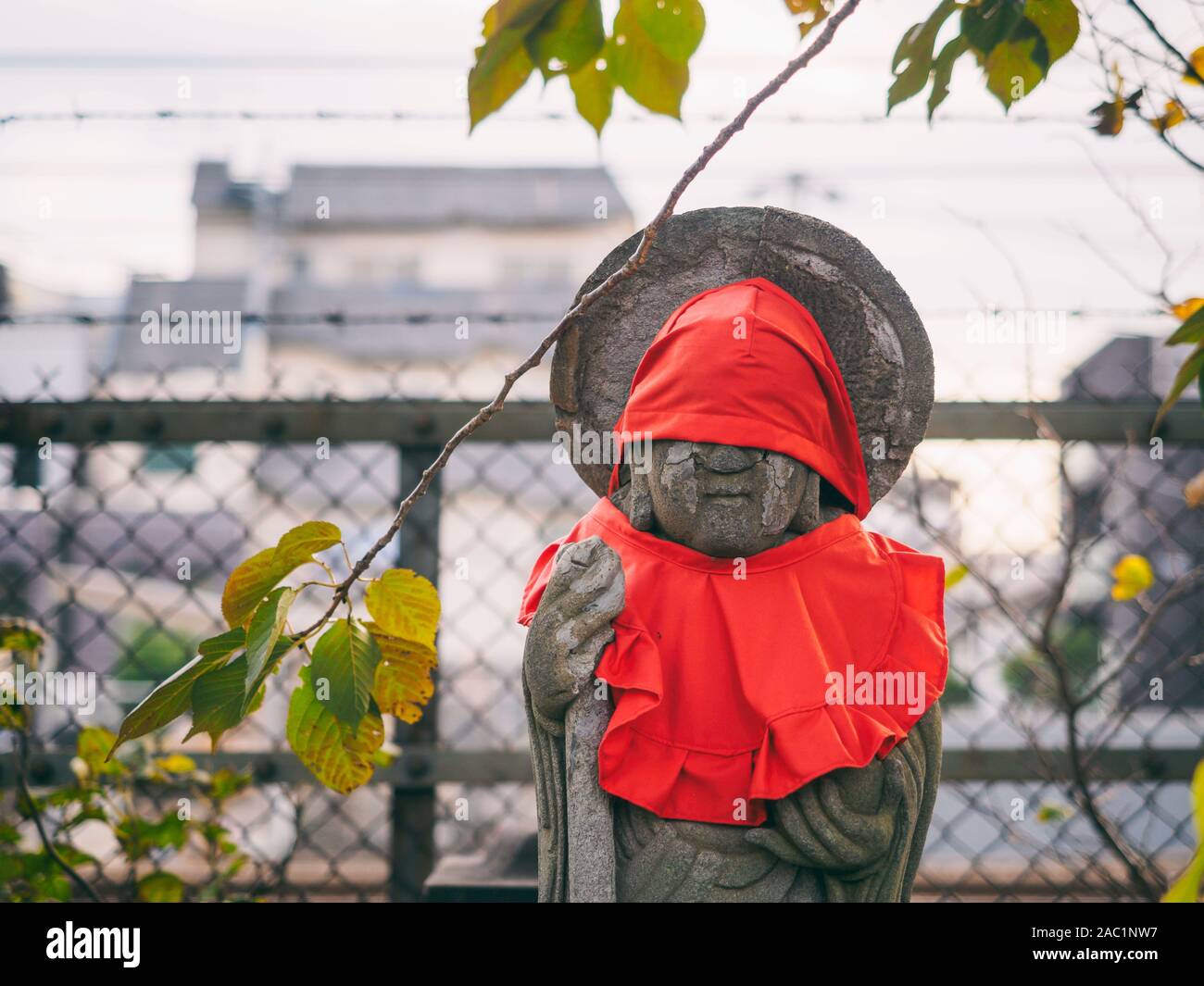 Jizo stone statues wearing a red apron in a shrine garden, Tokyo, Japan Stock Photo Alamy