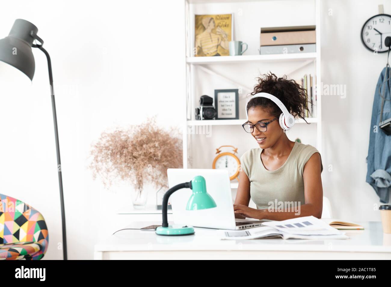 Image of a pretty happy positive optimistic young african woman sit in ...