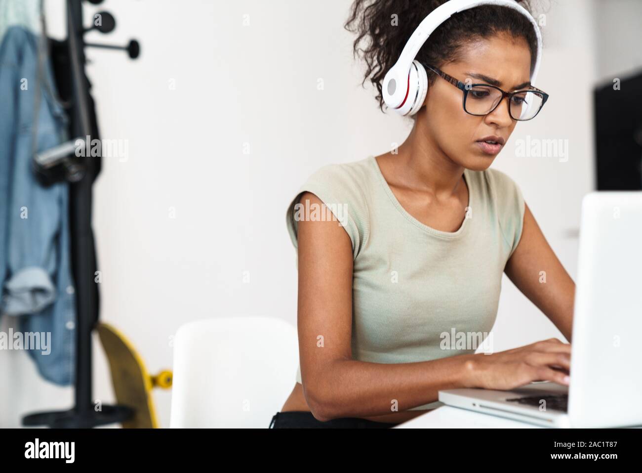 Image of a pretty concentrated young african woman sit in office using ...
