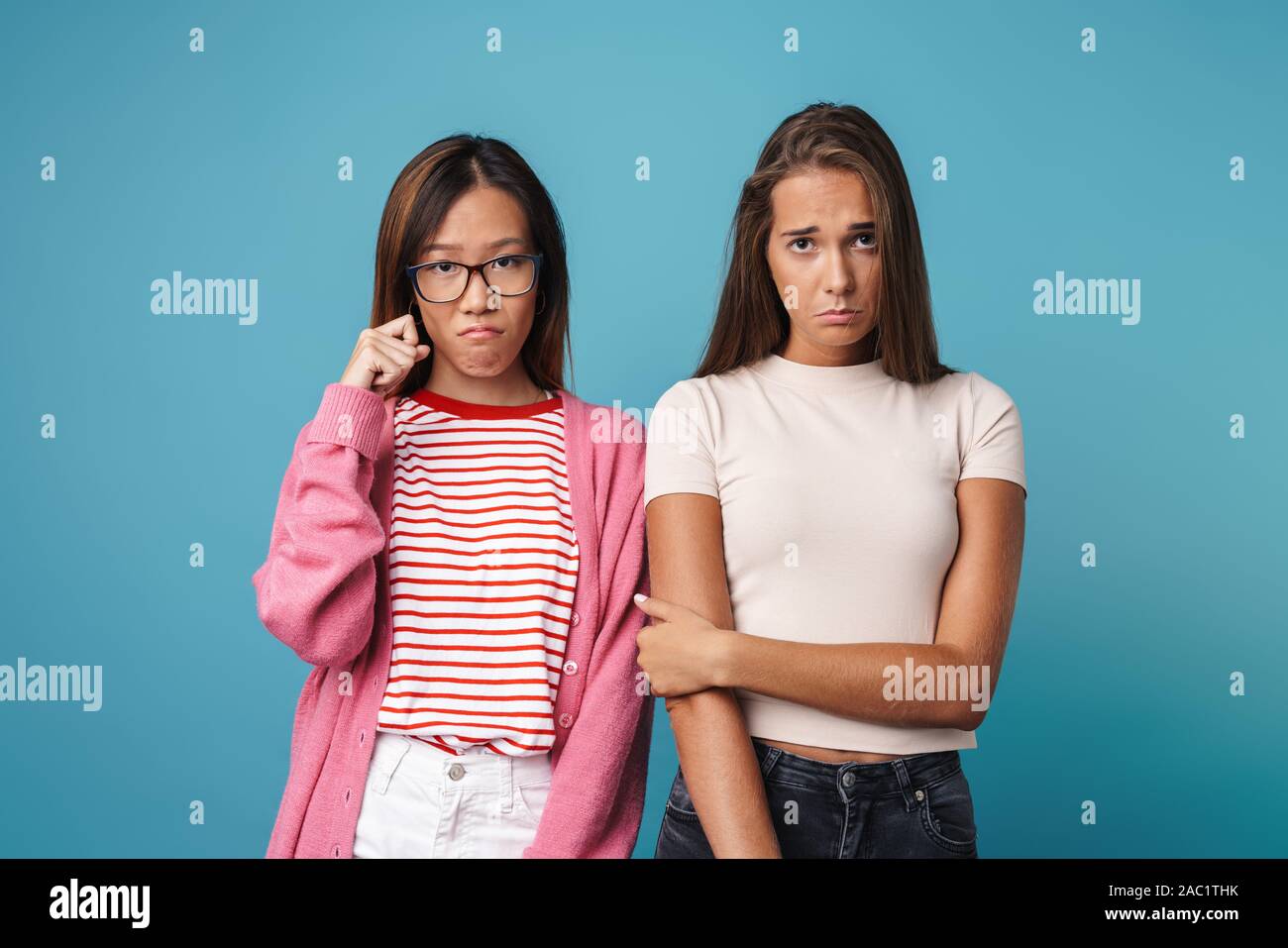 Portrait of multinational upset women looking at camera and crying ...