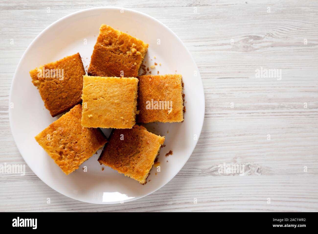 Homemade Sliced Cornbread Ready to Eat on a white plate over white ...