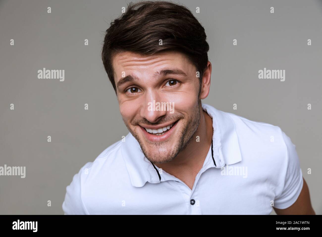 Image of a happy positive handsome young man posing isolated over grey ...