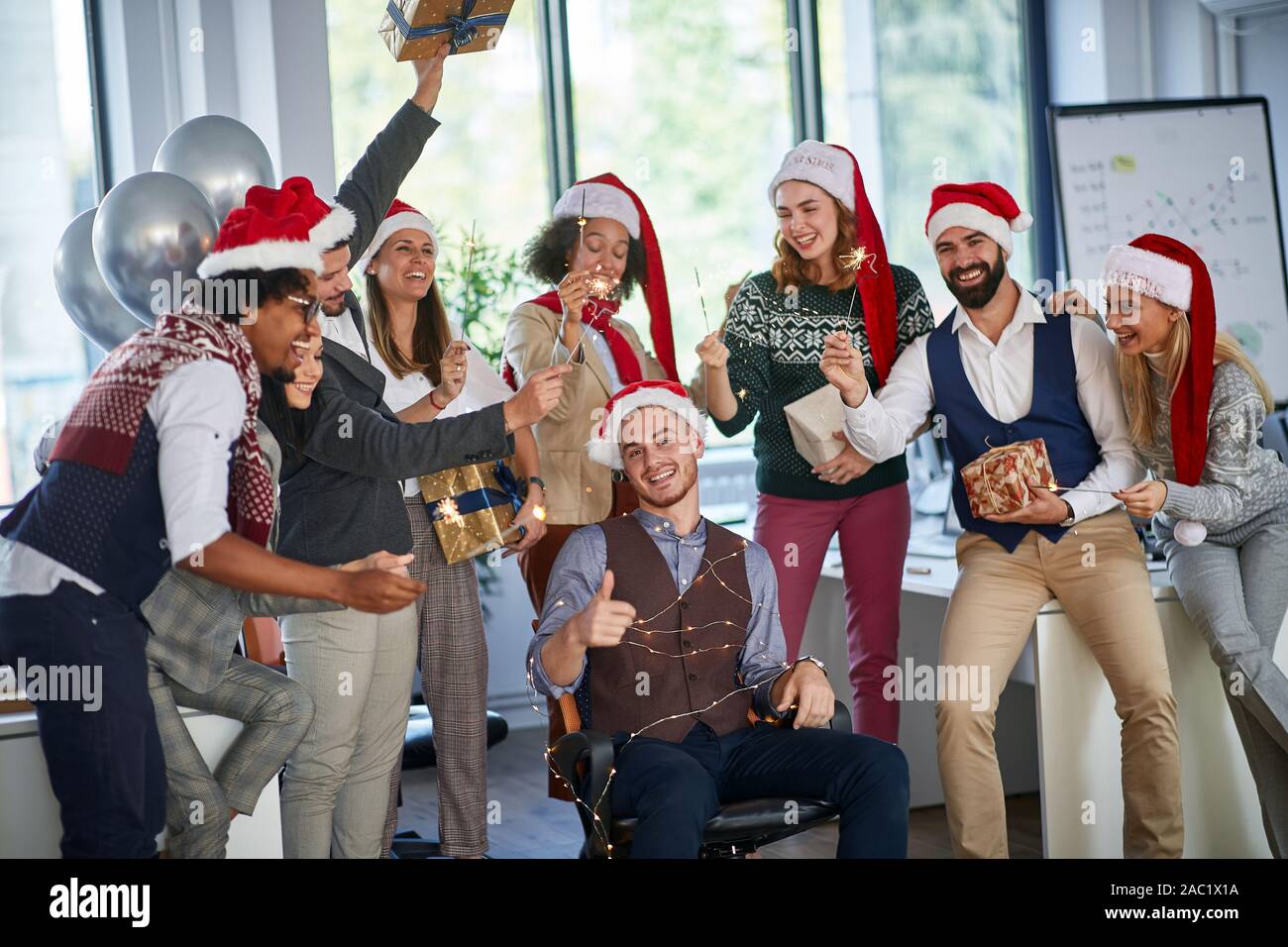 winter holidays at work. Group of young happy business people  celebrating Christmas Stock Photo