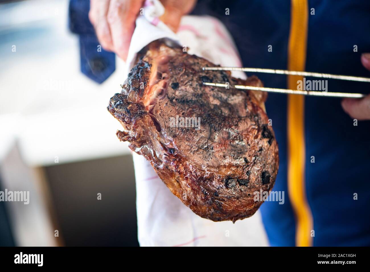 High end barbeque with expensive meat direct in the ash Stock Photo