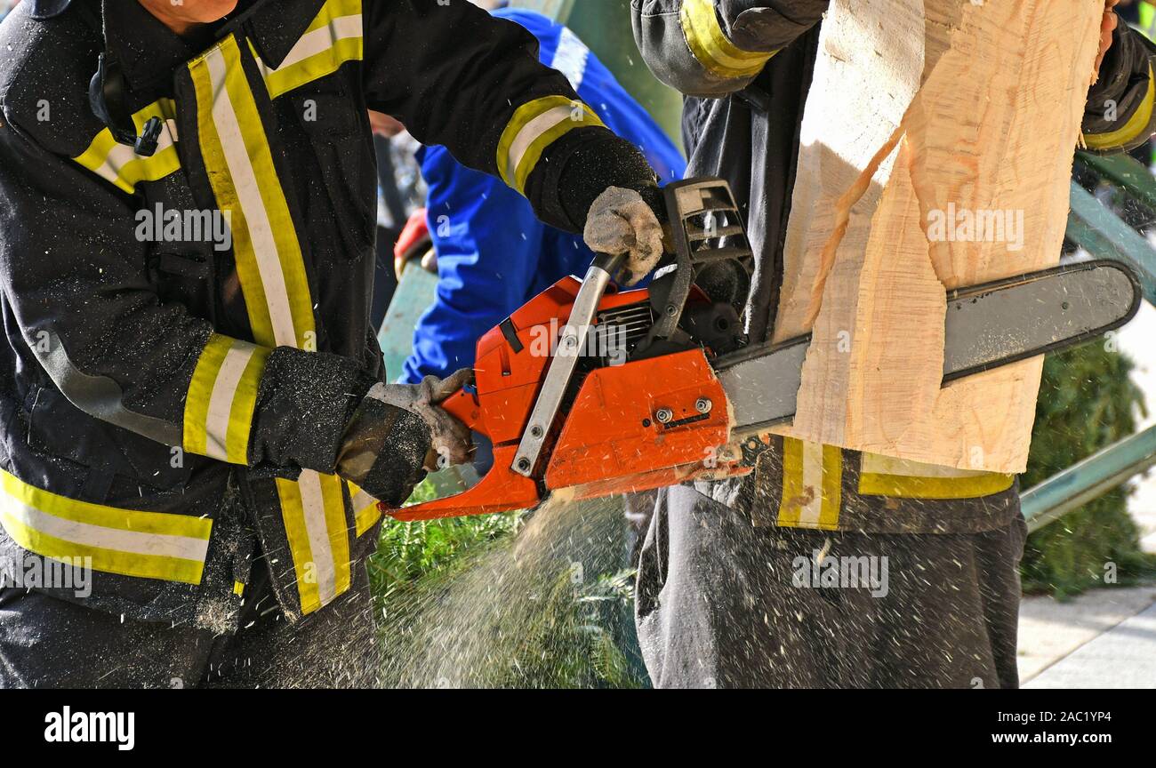 Firefighter works with a chainsaw outdoor Stock Photo Alamy