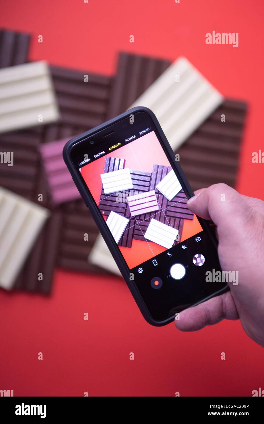 Mobile photography of pieces of delicious and tasty variations, white, brown and pink  famous KitKat chocolate bars Stock Photo
