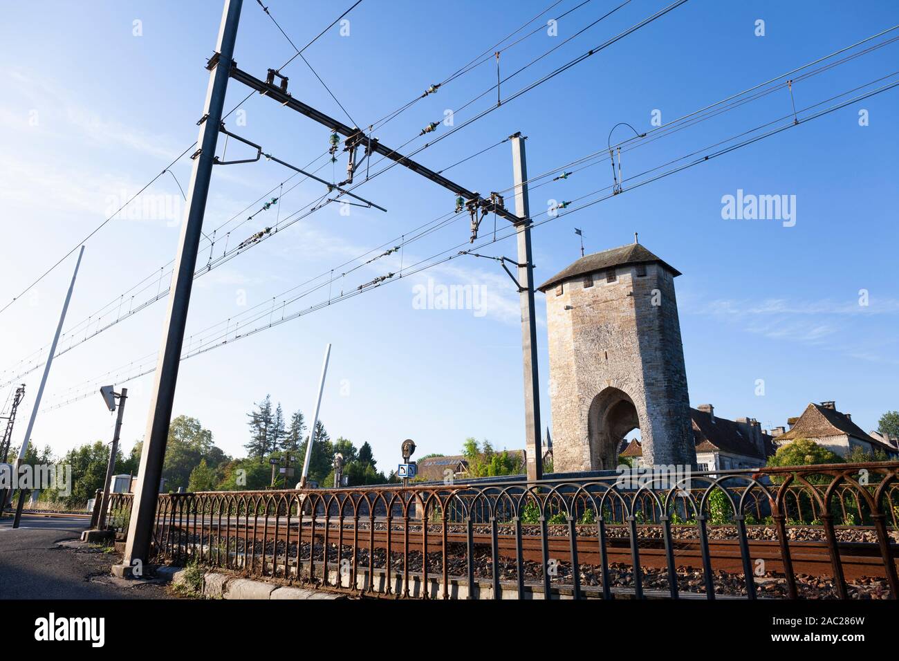 Europe, France, Nouvelle-Aquitaine, Orthez, 14th Century Stone Bridge across the Gave de Pau with Electrified Railway Line Stock Photo
