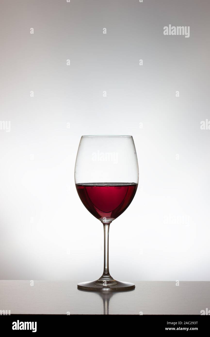 Full and half full red wine glass hi-res stock photography and images ...