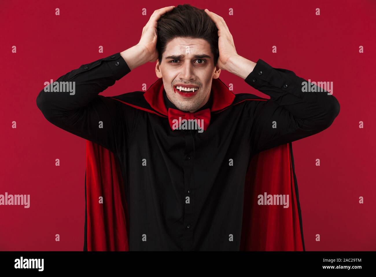 Image Of Shocked Vampire Man With Blood And Fangs In Black