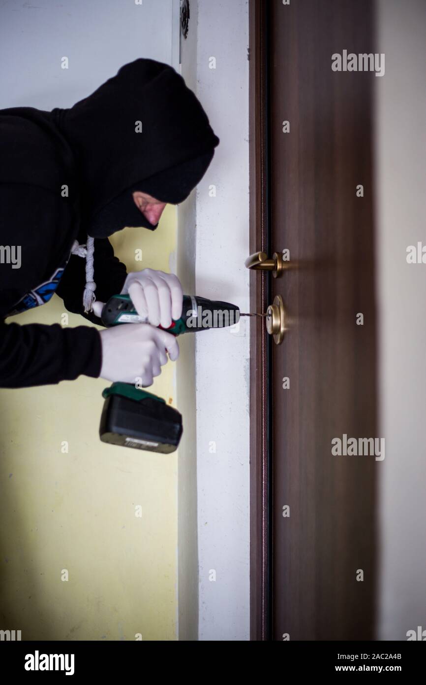 Crime Robbery Masked Thief Burglar Trying To Break Into A Flat