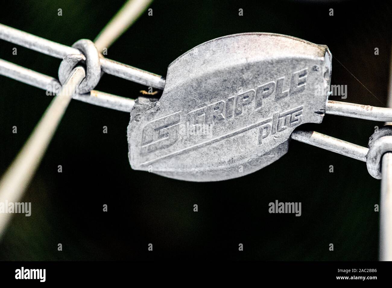 Close-up of a Gripple wire joiner attached to a steel wire fencing. Stock Photo