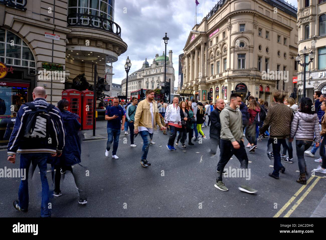 London, United Kingdom - September 7, 2019: Numerous motion blurred tourists crossing road in Haymarket in central London UK Stock Photo