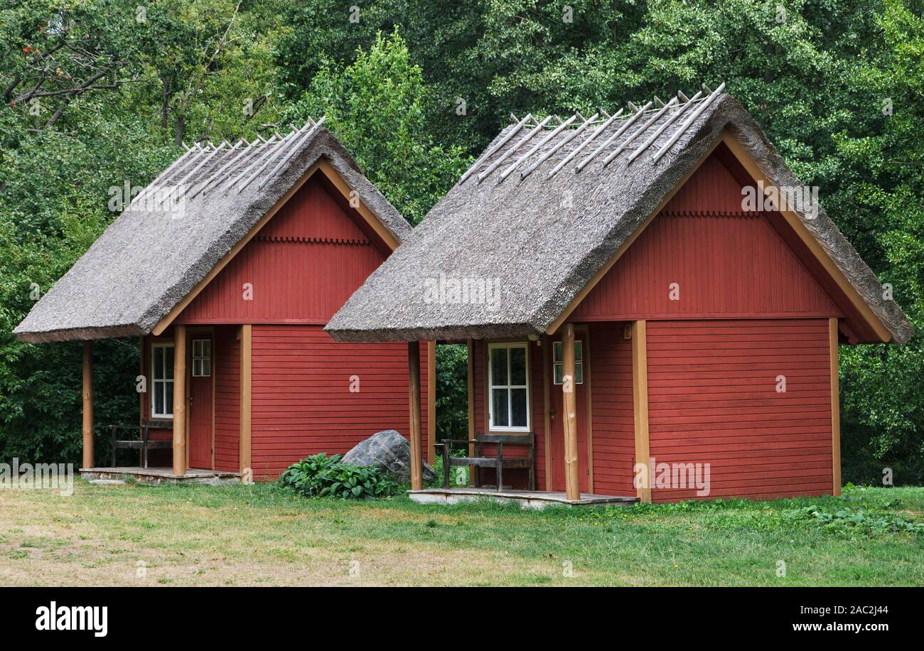 Small Red Wooden Cottages With Straw Roof Stock Photo 334430996