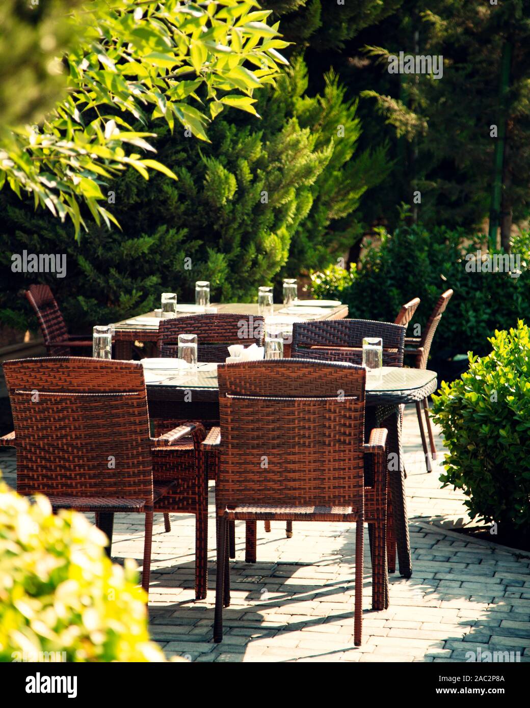tables and chairs in the garden Stock Photo - Alamy