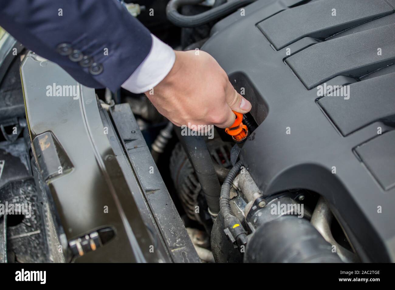 Checking the level of oil in the car's engine, to protect against