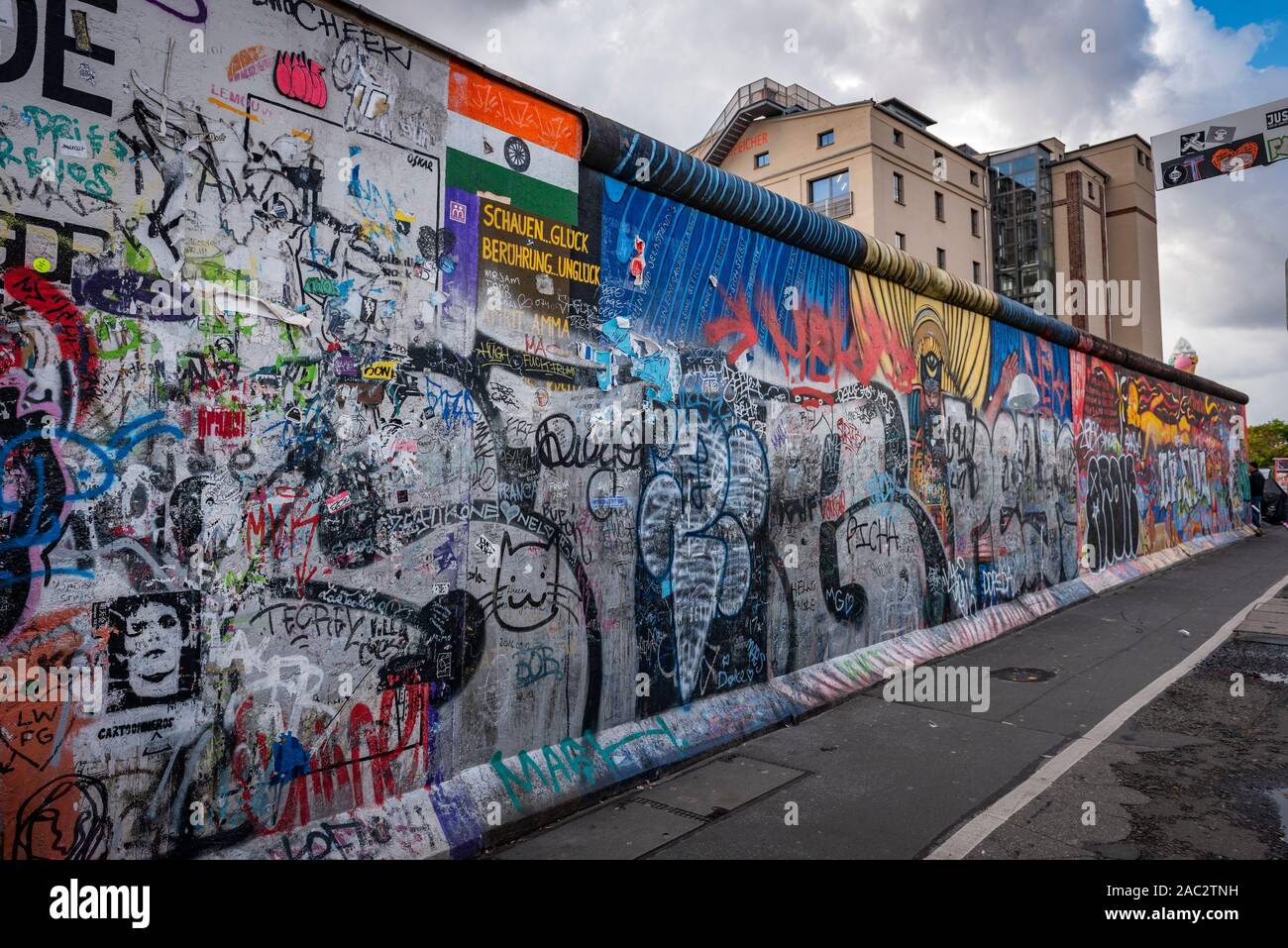Paintings and graffiti on the remains of the Berlin Wall in Germany Stock Photo